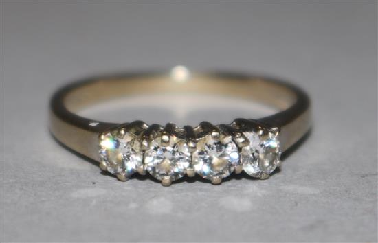 A modern 18ct gold and four stone diamond ring, size J.